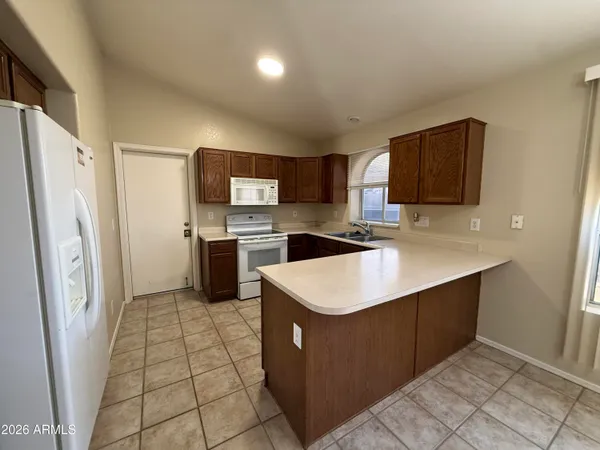 a kitchen with stainless steel appliances a refrigerator sink and microwave