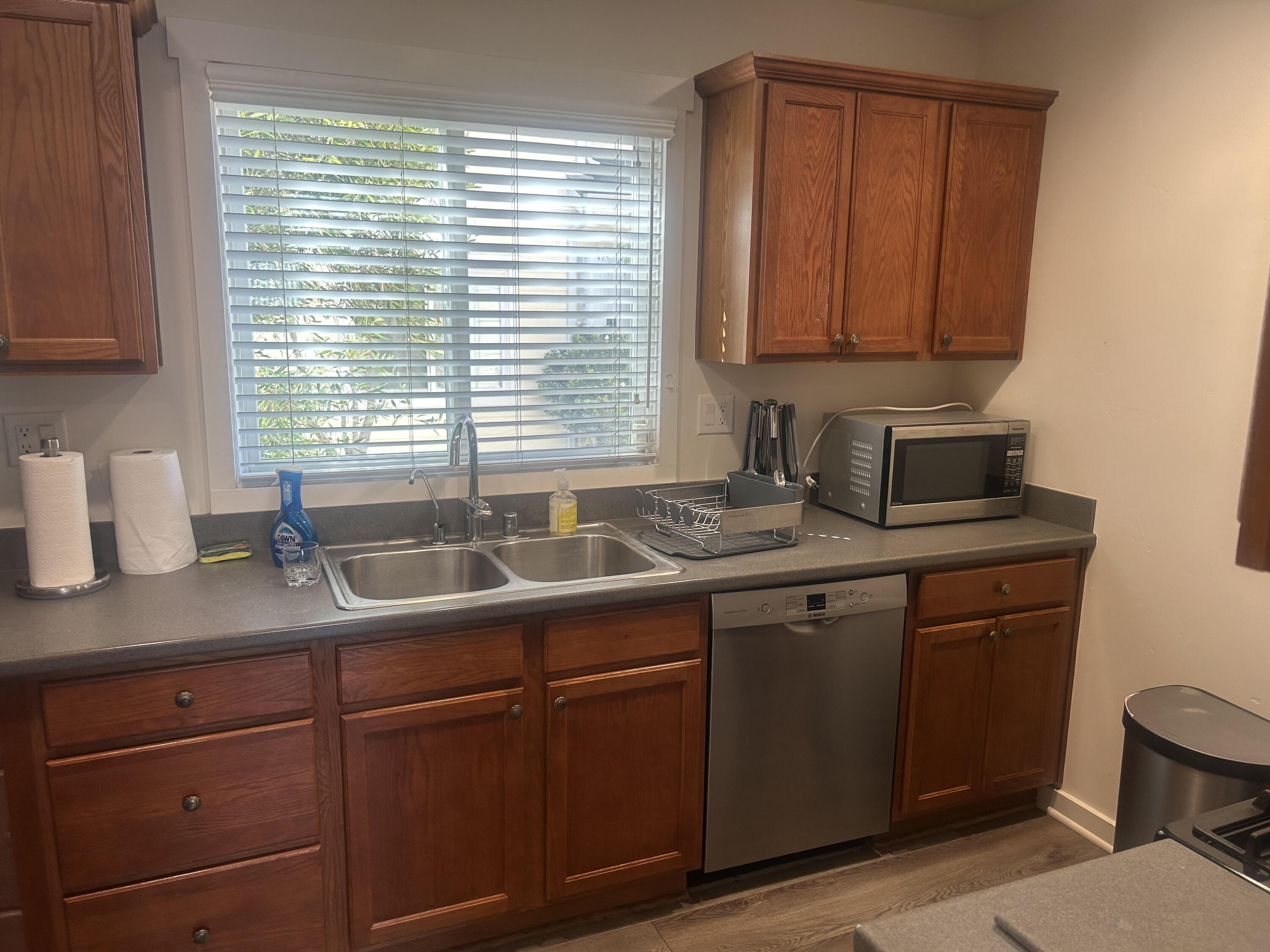 4858 5th Street Carpinteria, CA 93013 - Photo 3 of 10 a kitchen with stainless steel appliances granite countertop cabinets sink and window