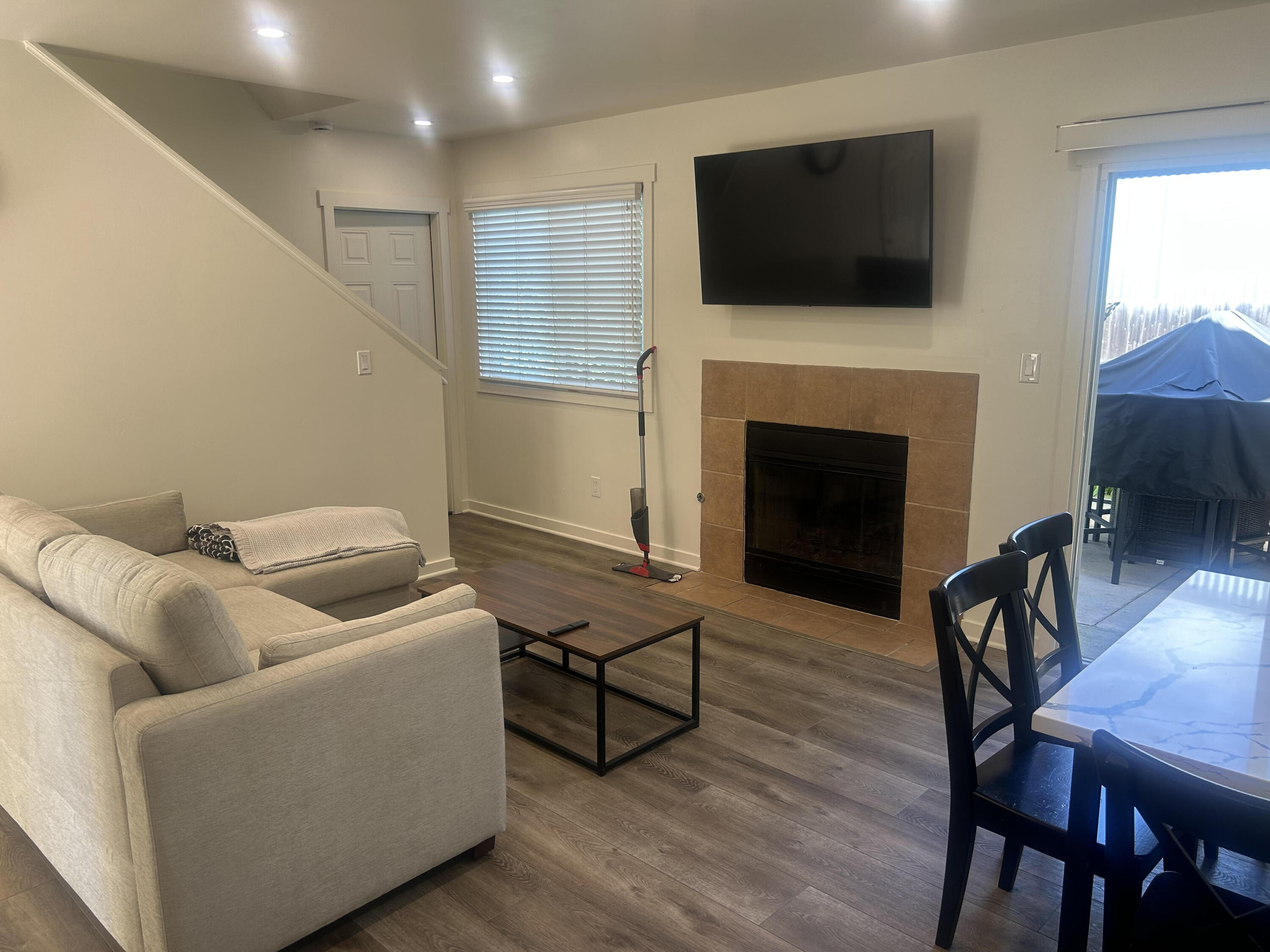 4858 5th Street Carpinteria, CA 93013 - Photo 5 of 10 a living room with furniture a flat screen tv and a fireplace