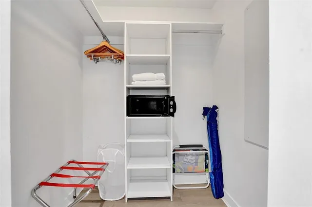 a bedroom with bed and night stand