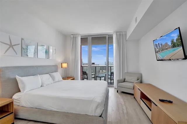 a kitchen with stainless steel appliances granite countertop white cabinets a microwave a sink and a refrigerator