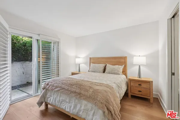 a bedroom with a bed and a large window