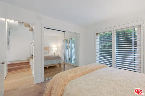 a bedroom with a bed and a mirror