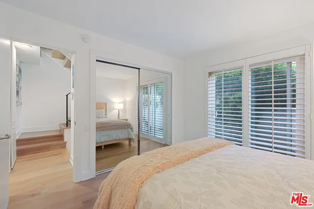 a bedroom with a bed and a mirror