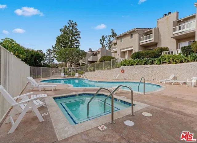 a view of a patio with table and chairs potted plants with wooden fence