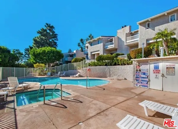 a view of a swimming pool with lounge chairs