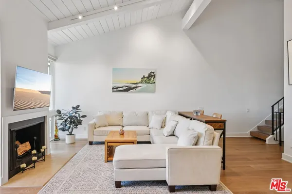 a view of a dining room and hall with wooden floor