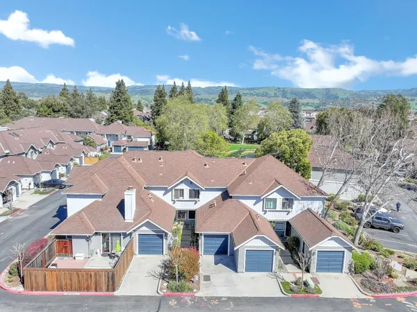 an aerial view of residential houses with outdoor space