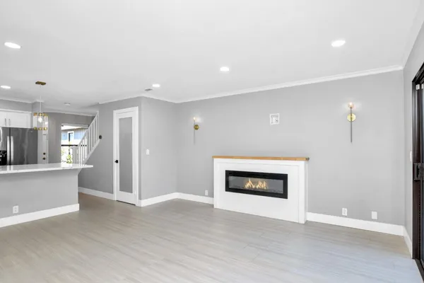a view of an empty room with a fireplace and a window