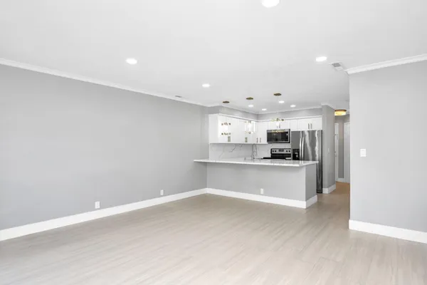 a kitchen with a sink and a refrigerator