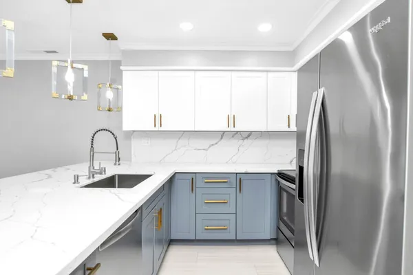 a kitchen with a sink a counter top space and appliances