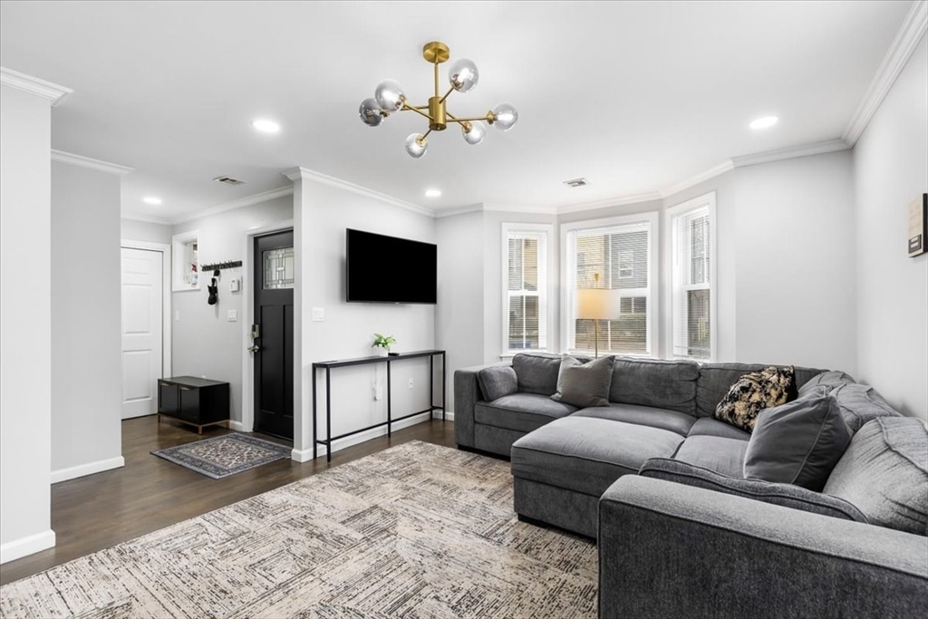 77 Cedar Street Boston, MA 02119 - Photo 5 of 25 a living room with furniture and a flat screen tv