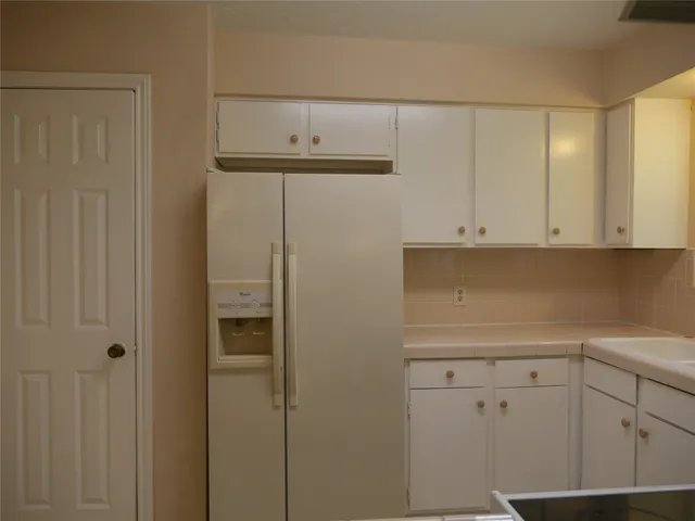 a view of cabinets and wooden floor