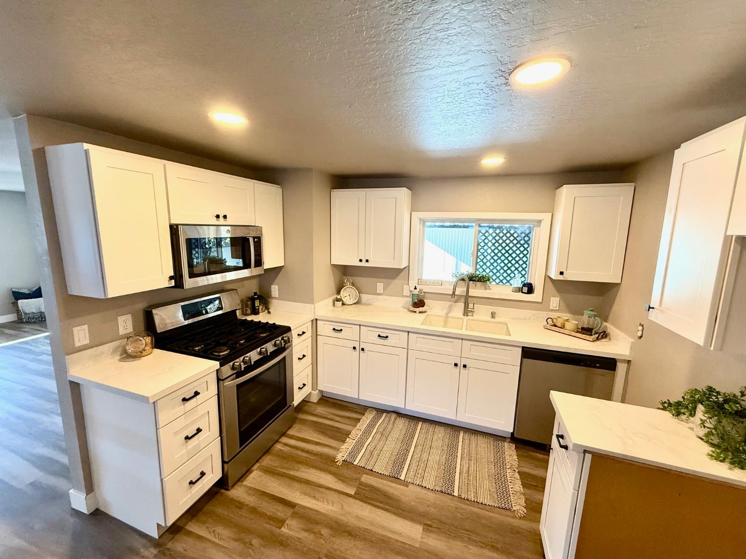 a kitchen with a sink stove and microwave