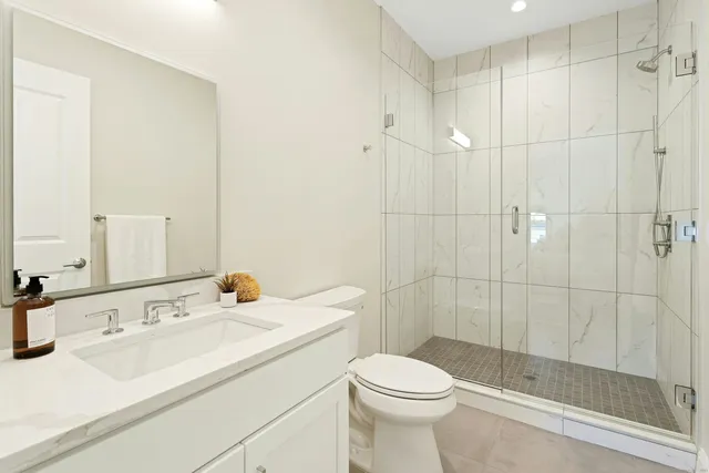 a bathroom with a sink toilet and shower