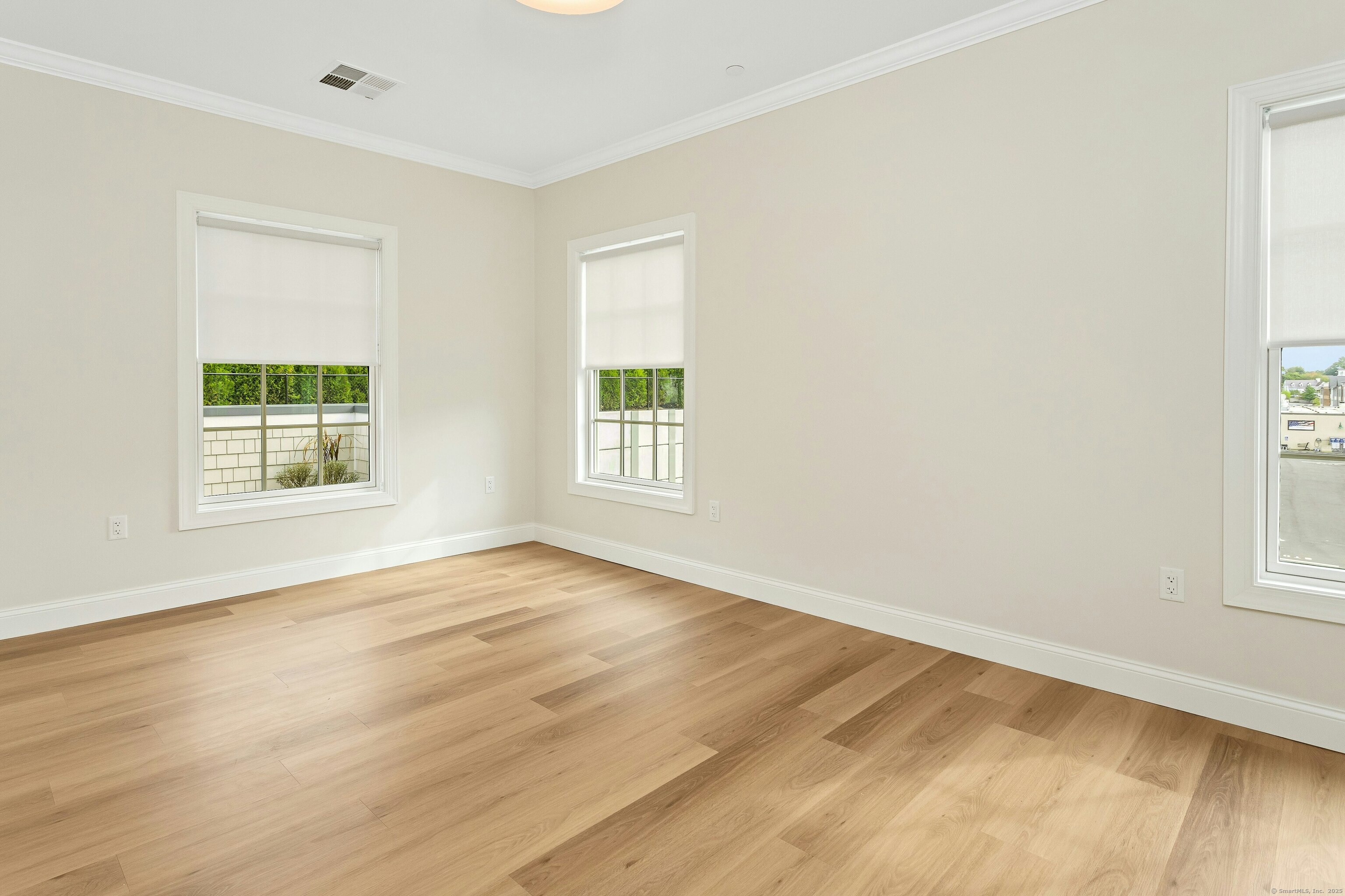 340 Heights Road, Unit 319 Darien, CT 06820 - Photo 13 of 21 an empty room with wooden floor and windows
