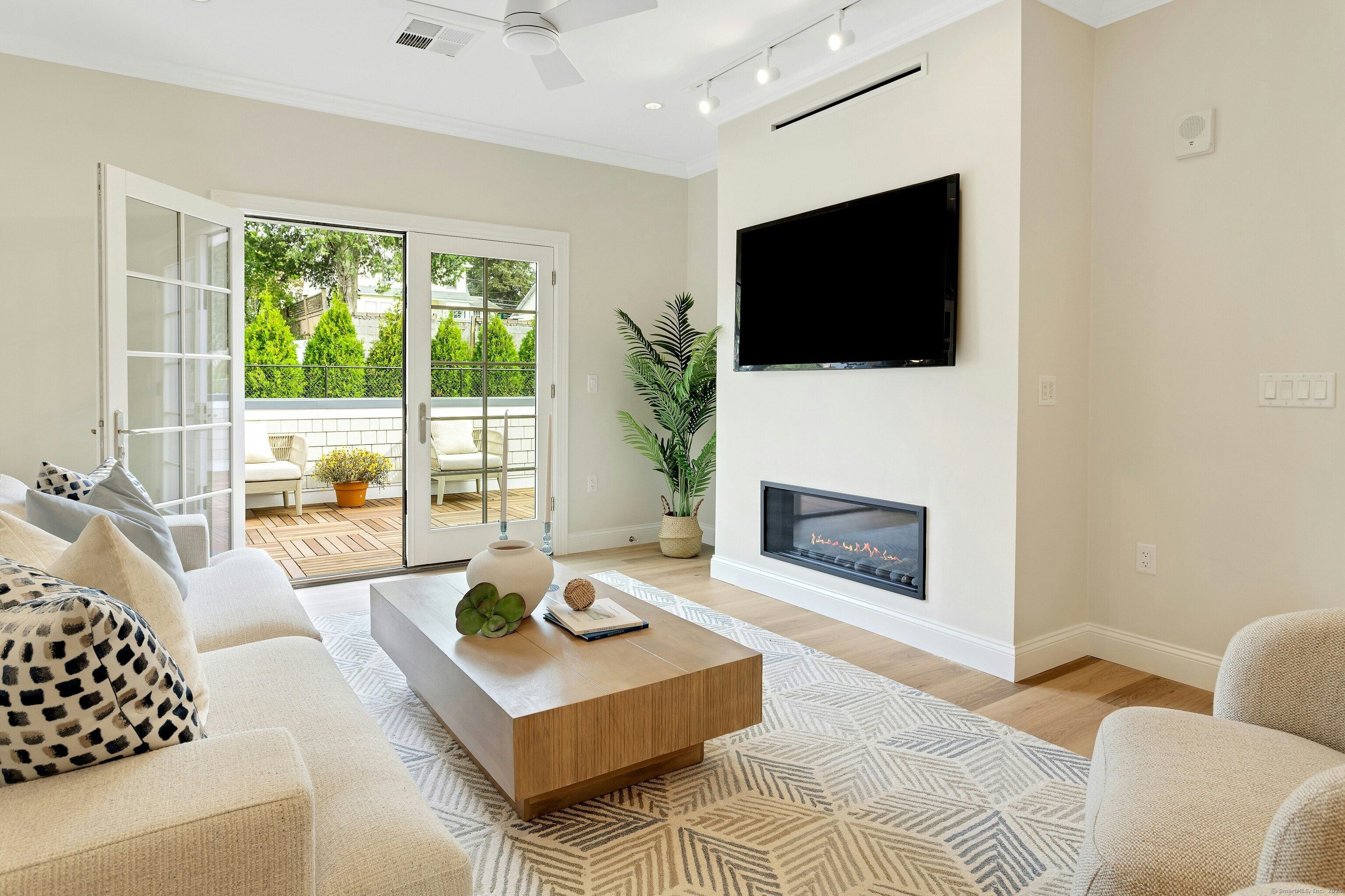 340 Heights Road, Unit 319 Darien, CT 06820 - Photo 2 of 21 a living room with furniture a flat screen tv and a fireplace