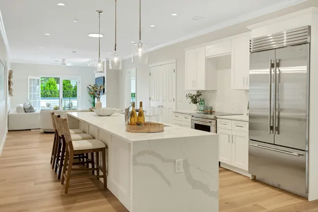 a kitchen with kitchen island a table and chairs in it