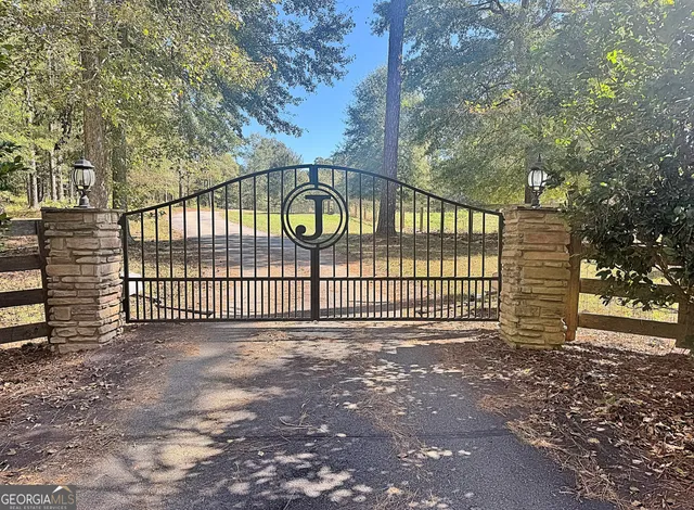 a kitchen with stainless steel appliances granite countertop a stove top oven a sink a dining table and chairs with wooden floor