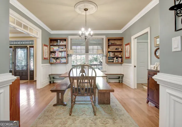 a bedroom with a bed chandelier and a window