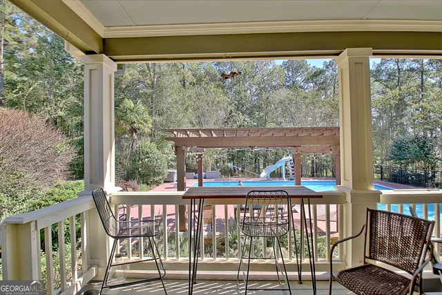 a view of a porch with a table and chairs