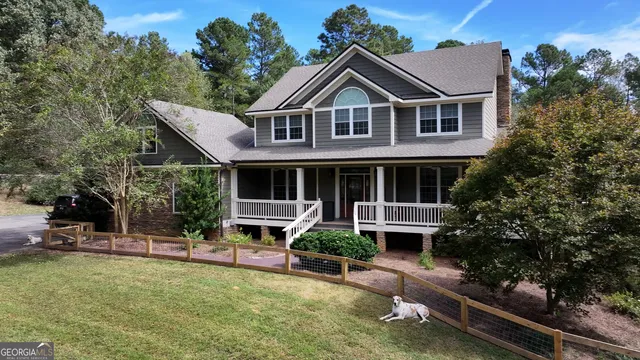 a view of a yard with wooden fence