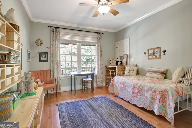 an aerial view of residential house with outdoor space and trees all around