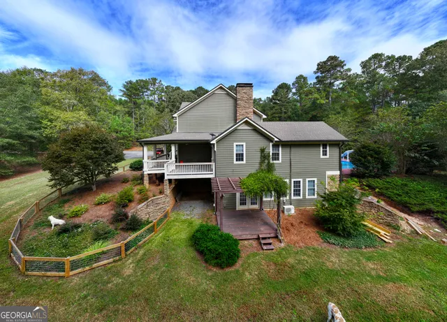a kitchen with kitchen island a dining table chairs cabinets and stainless steel appliances