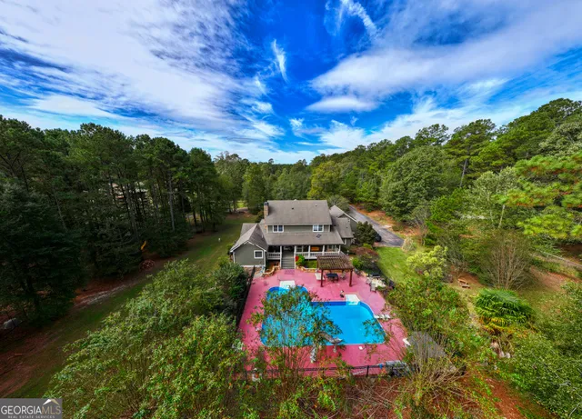 a kitchen with stainless steel appliances granite countertop a stove top oven a sink dishwasher and white cabinets with wooden floor