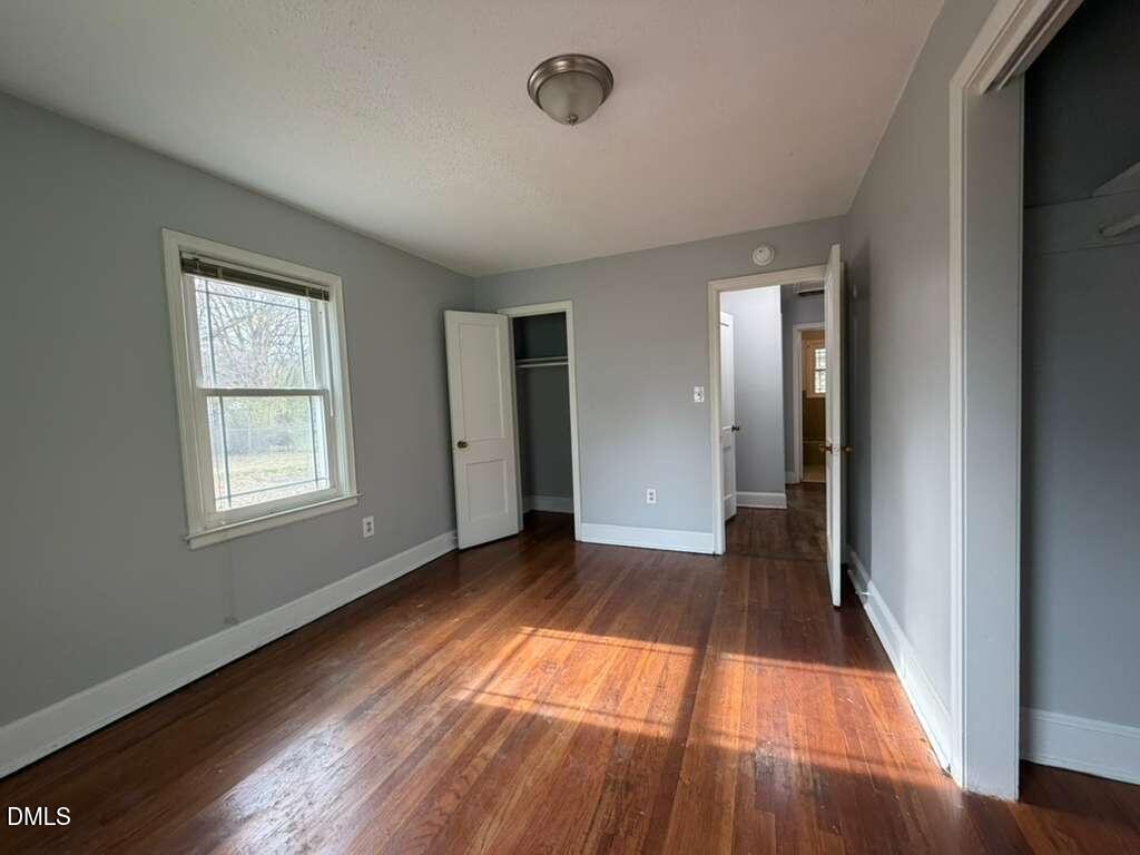 1419 Leon Street Durham, NC 27705 - Photo 12 of 23 a view of an empty room with wooden floor and a window
