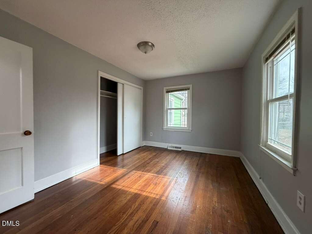 1419 Leon Street Durham, NC 27705 - Photo 13 of 23 a view of an empty room with wooden floor and a window