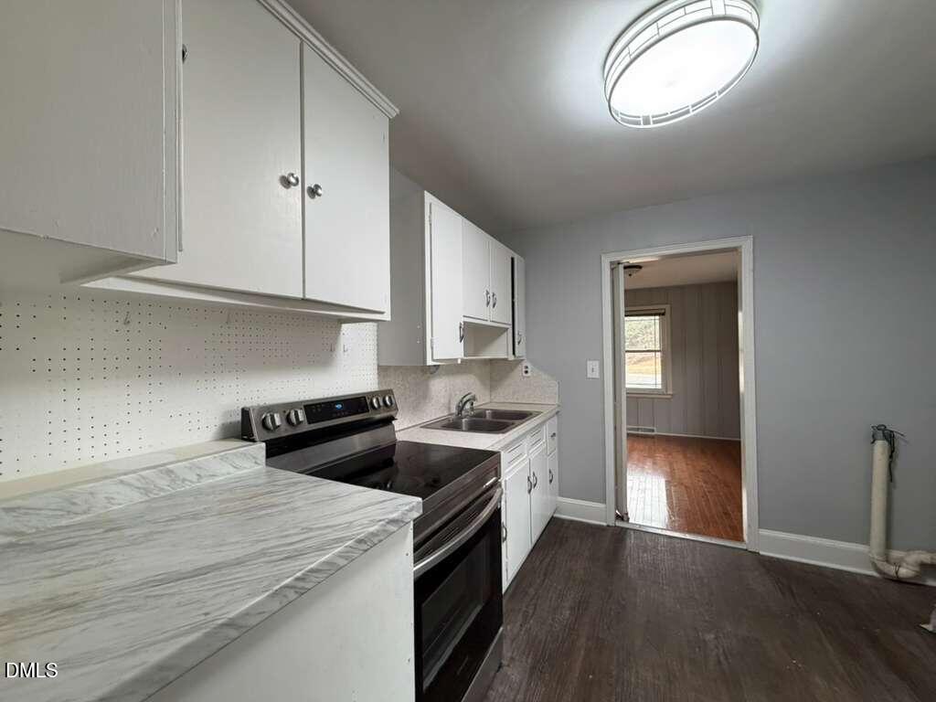1419 Leon Street Durham, NC 27705 - Photo 17 of 23 a kitchen with a stove and a wooden floors