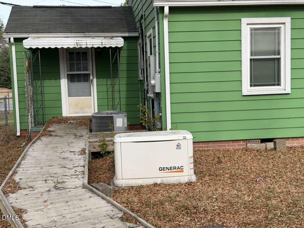 1419 Leon Street Durham, NC 27705 - Photo 4 of 23 a small white building with a large window and potted plants
