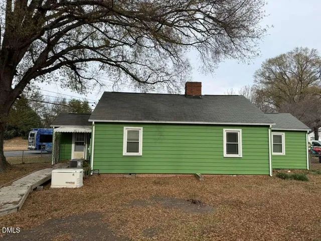 a view of a house with a yard and garage