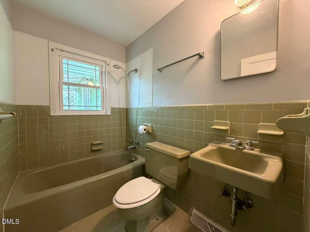 1419 Leon Street Durham, NC 27705 - Photo 10 of 23 a bathroom with a sink a toilet and shower