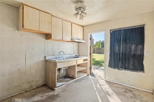 a front view of a house with a yard covered with snow