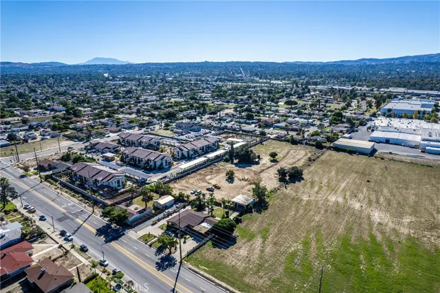an aerial view of a residential houses with outdoor space