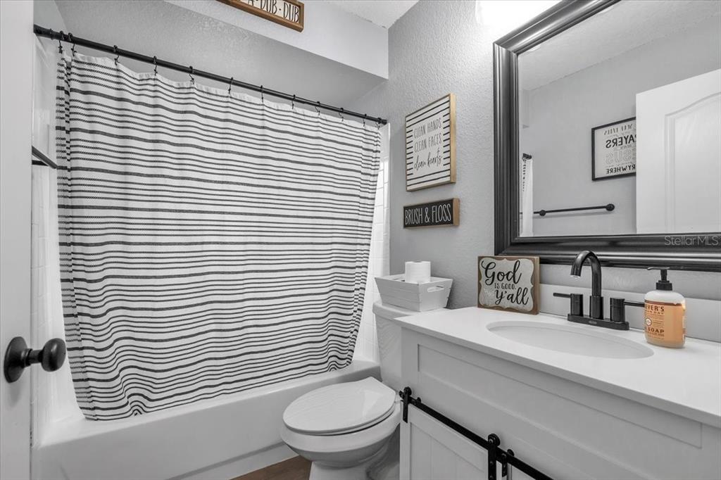 29350 Goodhue Street Punta Gorda, FL 33982 - Photo 15 of 21 a bathroom with a toilet a sink and mirror