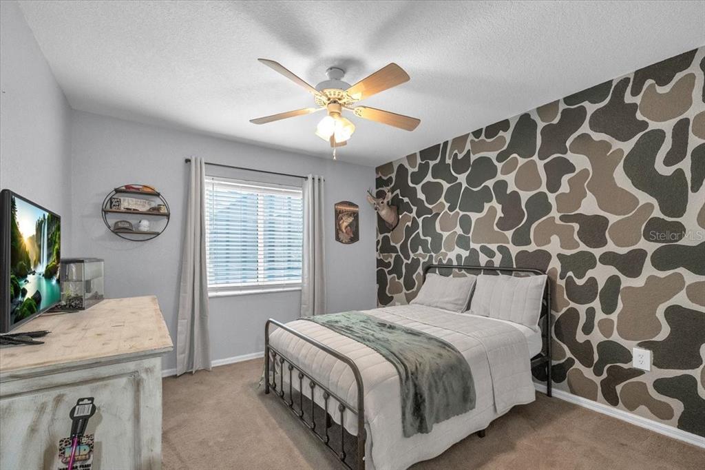 29350 Goodhue Street Punta Gorda, FL 33982 - Photo 16 of 21 a bedroom with a bed and a chandelier