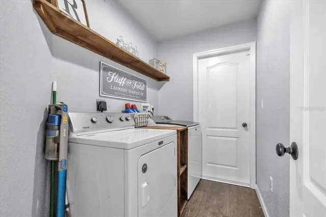 a view of a hallway with washer and dryer