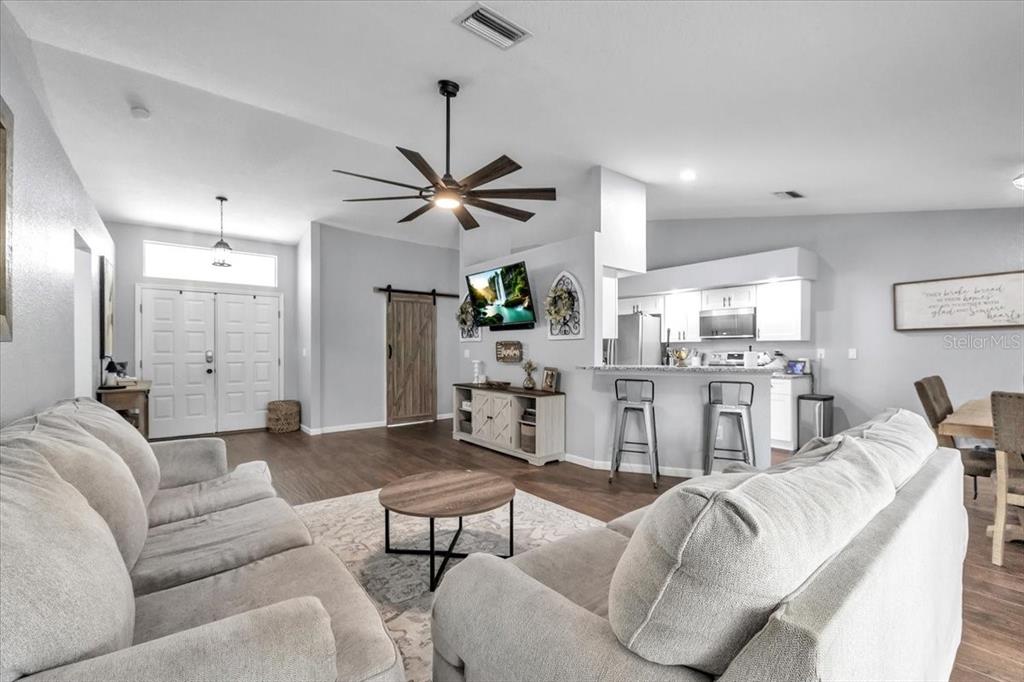 29350 Goodhue Street Punta Gorda, FL 33982 - Photo 8 of 21 a living room with furniture kitchen view and a chandelier