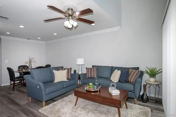 a living room with furniture and a chandelier