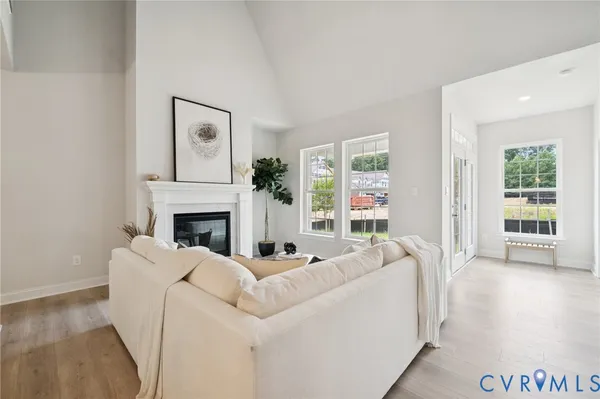 a living room with furniture a window and a fireplace