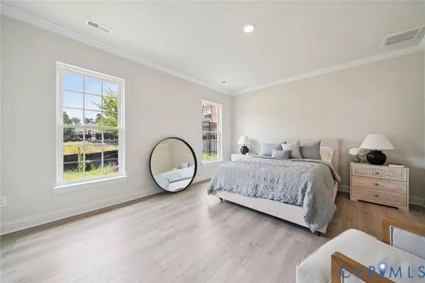 a spacious bedroom with a bed and a large window