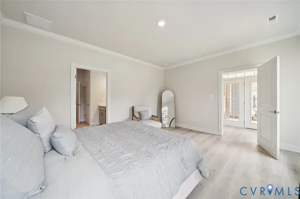 a large white bed in a white room