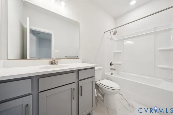 a bathroom with a sink a toilet and a large mirror