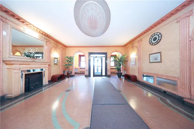 a lobby with furniture and fireplace