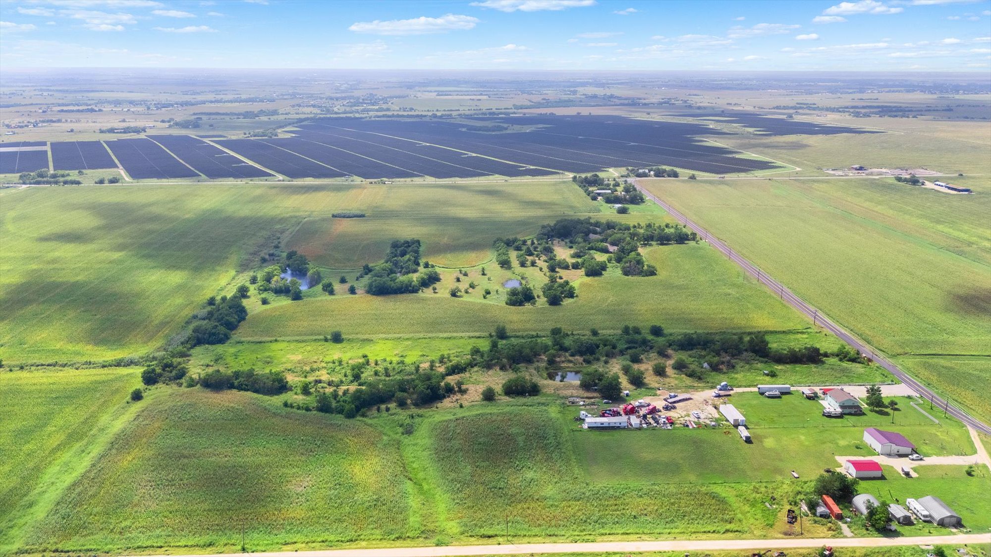 14201 Lund - Carlson Road Coupland, TX 78615 - Photo 2 of 40 Sprawling acreage offers a mix of verdant fields, a solar farm, and multiple residential structures.