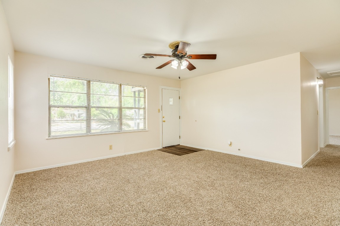 837 Pin Money Street Clute, TX 77531 - Photo 11 of 24 a view of a big room with windows and chandelier fan