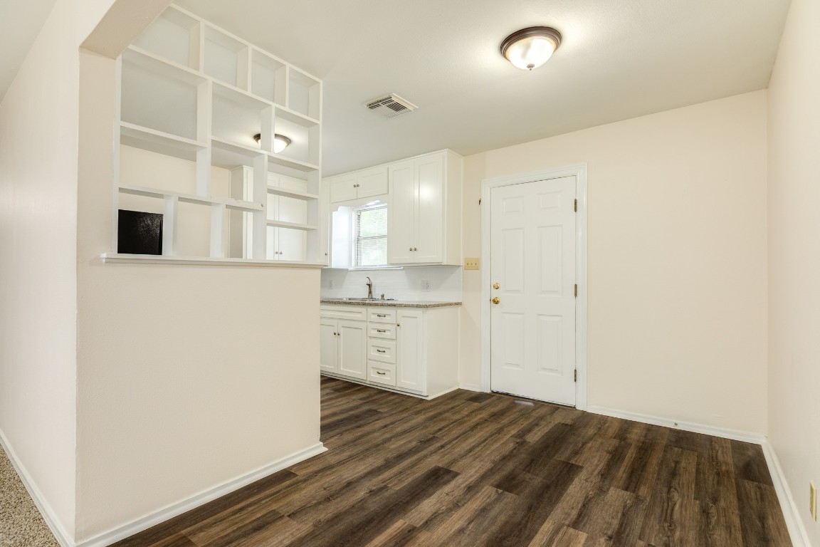 837 Pin Money Street Clute, TX 77531 - Photo 14 of 24 a view of a kitchen with wooden floor and a sink